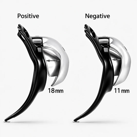 Side-profile comparison of the resin chastity cage, labeled Positive 18 mm and Negative 11 mm.