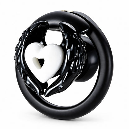 Angel wing inverted chastity cage with black feathered wings, a white heart centerpiece and a black base ring.