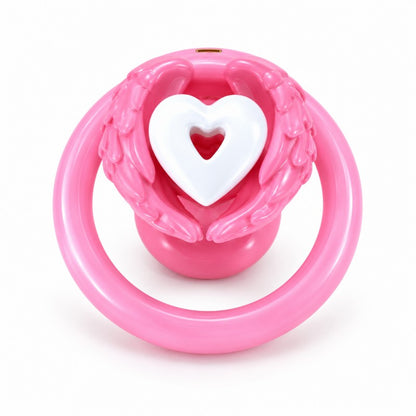 Angel wing inverted chastity cage with pink feathered wings, a white heart centerpiece and a pink base ring.