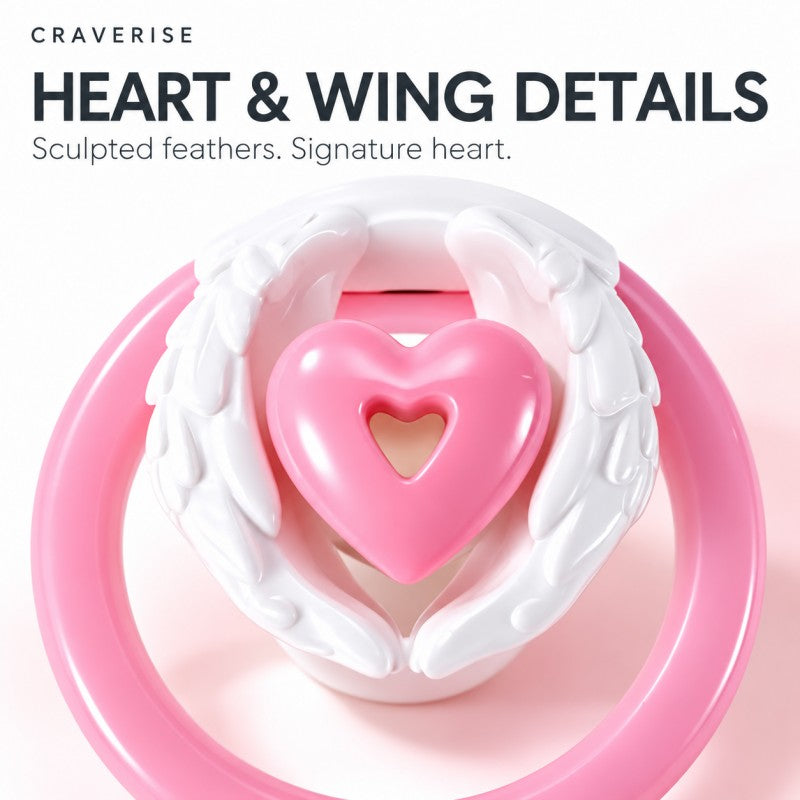Close-up of sculpted white feathered wings and the pink heart-shaped centerpiece of an inverted chastity cage.