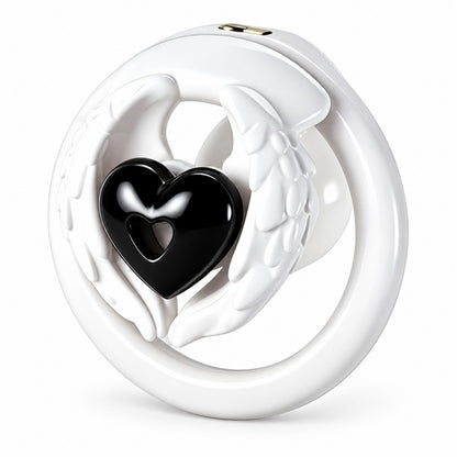 Angel wing inverted chastity cage with white feathered wings, a black heart centerpiece and a white base ring.
