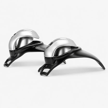 Two side views of silver shells mounted on black resin chastity cage bases.